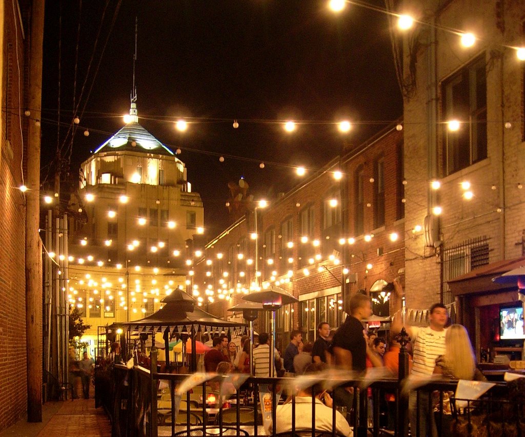 Night time image of a busy East village outdoor patio scene.