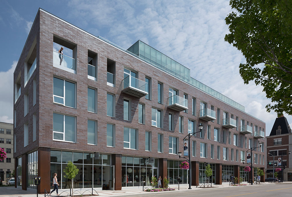 Exterior image showing the full east locust street facade, highlighting the retail stores below.